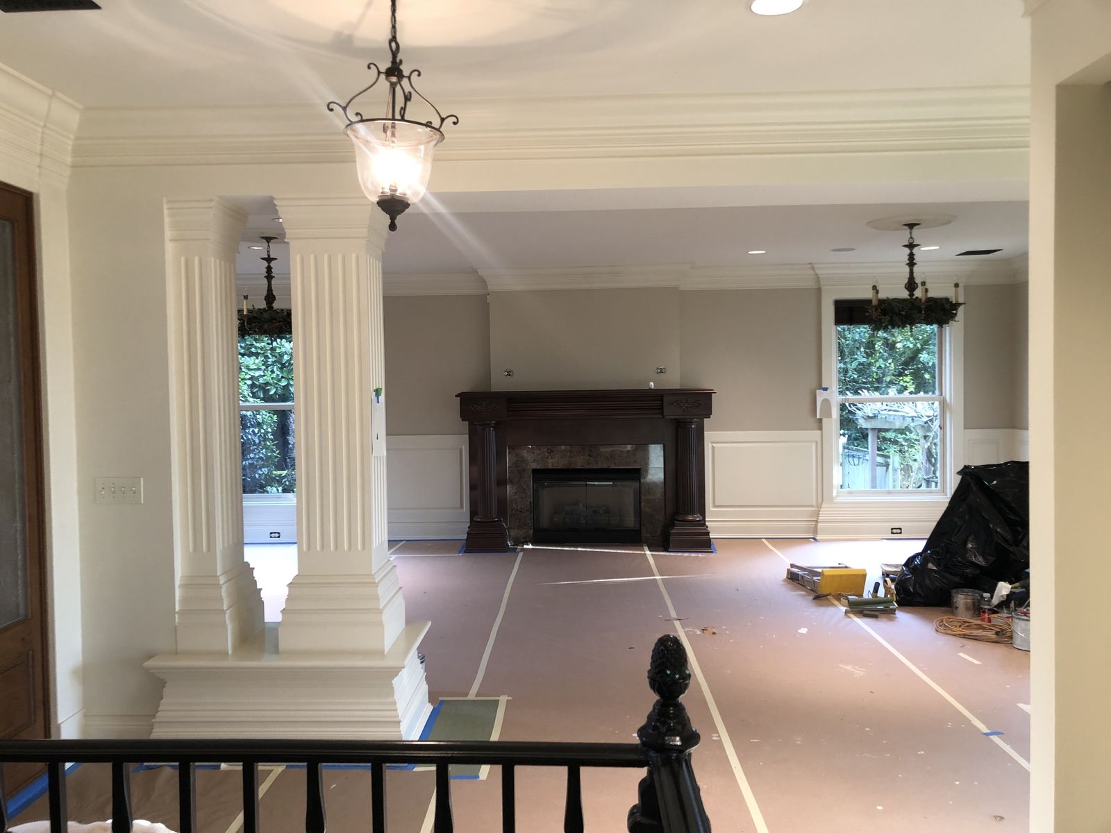 Painted living room with columns, high ceiling and white trim