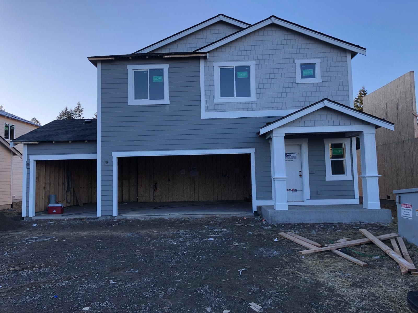 Two-story home exterior painted blue-gray with crisp white trim