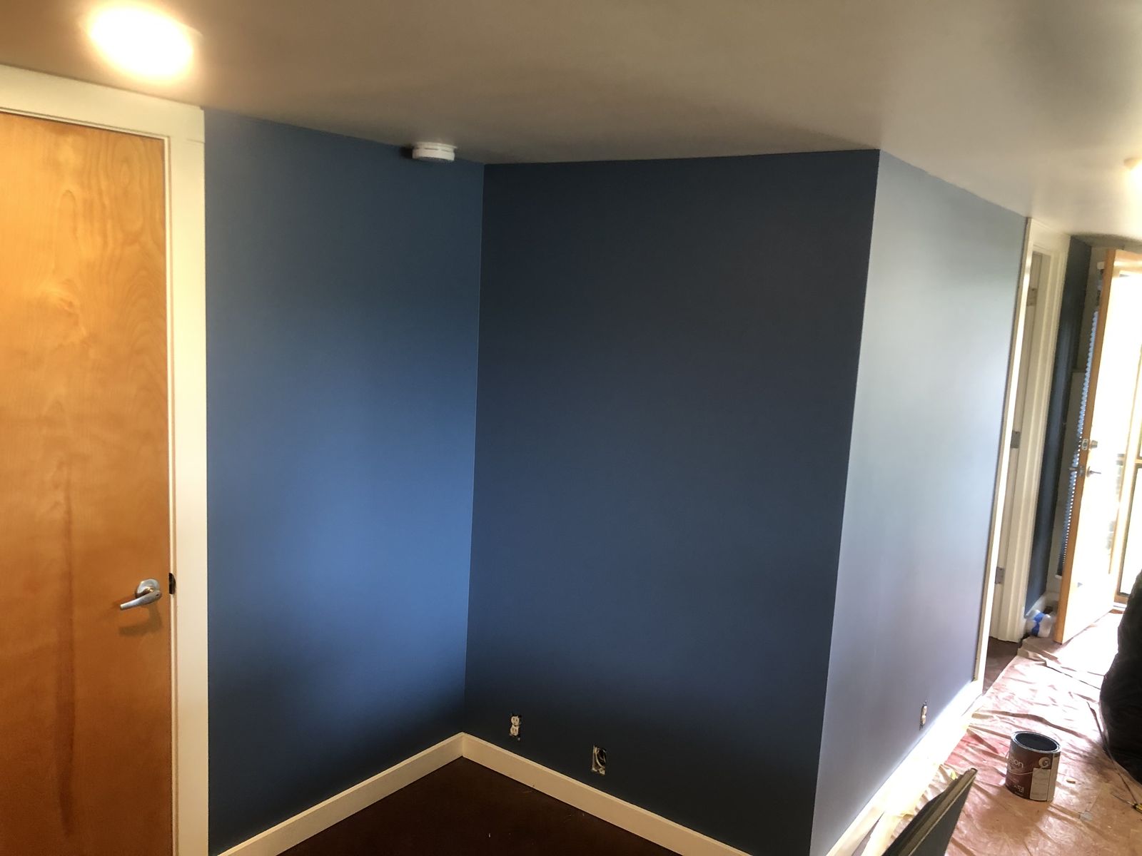 Interior corner painted in a deep slate blue with clean edges